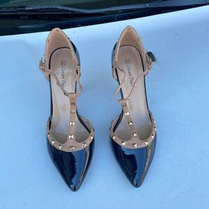 Navy blue with tan and the studs are gold